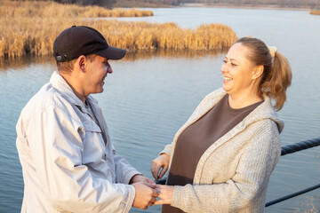 Casual middle-aged woman enjoys a coffee break while walking in park.