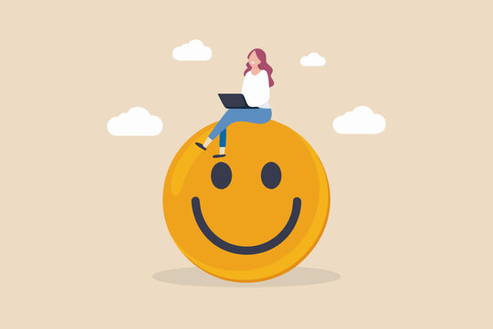 Happy freelancer working on laptop sitting on a giant smiley face icon