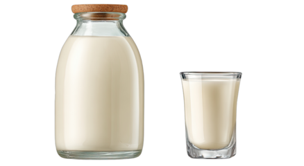 A glass bottle and shot glass filled with creamy white liquid against a white background
