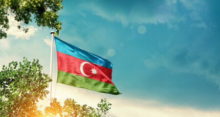 The Bahamas national flag waving in the sky behind the tree. The flag blowing with beautiful sunlight. The Bahamas national flag for independence day.