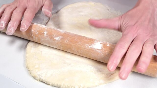 woman with roller pin working with dough
