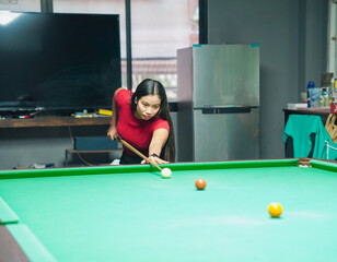 Asian Woman and friends stand playing snooker reaction enjoying happy fun Winning game. Young adults female active party club pool bar
