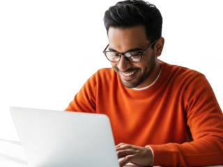 Smiling young man with glasses intently using laptop for work