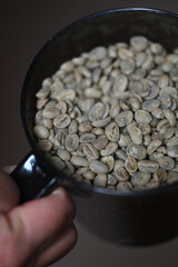 A cup of raw coffee beans