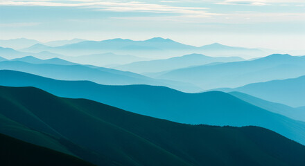 Serene mountain landscape with layered hills and blue sky.