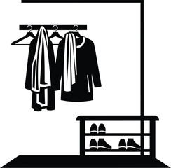 Black clothes rack with coats, hangers, and shoes for home organization