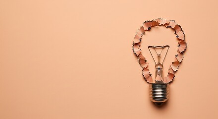Cleverly crafted light bulb symbol made from natural pencil shavings, representing bright ideas, innovation, and creative solutions