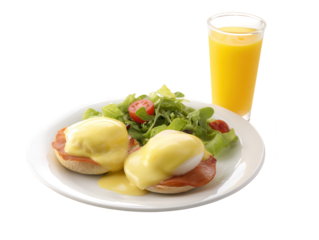 Plate of eggs Benedict with hollandaise sauce, served with orange juice