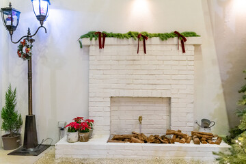 A charming Christmas setup featuring a Santa Claus figurine surrounded by small festive decorations and wrapped presents. The scene highlights warm holiday cheer with miniature ornaments, gift boxes, 