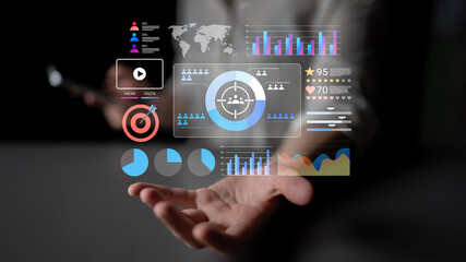 A person hand showcases a digital dashboard filled with various charts and graphs, illustrating business performance metrics and data analysis in a contemporary office setting. Gantry