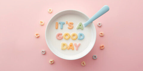 Overhead view of colorful alphabet cereal spelling its a good day in a bowl of milk