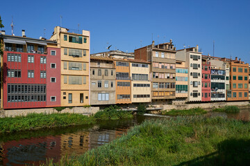 Facades facing the Onyar river in the section of the Rambla and Argenteria in different colors. Girona, Catalonia, Spain. 