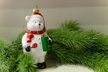 A charming Christmas setup featuring a Santa Claus figurine surrounded by small festive decorations and wrapped presents. The scene highlights warm holiday cheer with miniature ornaments, gift boxes, 