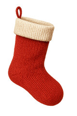 A cozy hand knitted red christmas stocking with a cream colored cuff hangs against a dark background ready to be filled with holiday gifts and treats for santa
