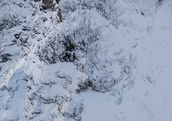 Snow Covered Rocky Mountain Slope Aerial View in British Columbia, Canada Wilderness Alpine Snowfields Terrain
