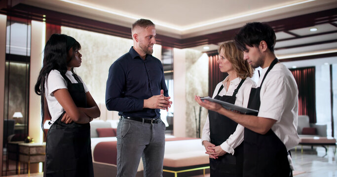 The Hotel Manager Leading A Team Meeting