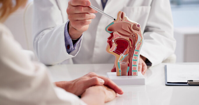 Doctor Examines A Woman's Thyroid Gland