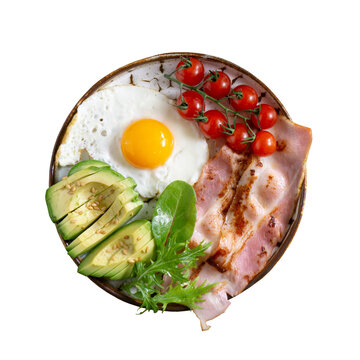 A delicious and nutritious breakfast plate featuring fried egg avocado bacon and cherry tomatoes