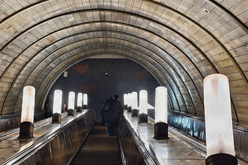 Еscalator moves in the subway. Illuminated path to the shelter