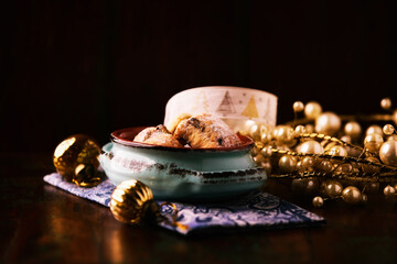Traditional christmas cookies in a bowl on a rustic wooden background. Soft focus.	