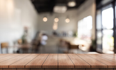 Empty wooden table top with lights bokeh on blur restaurant background.