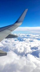 Obraz premium View from an airplane window, showing wing and clouds below