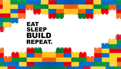 Colorful building blocks framing eat sleep build repeat text