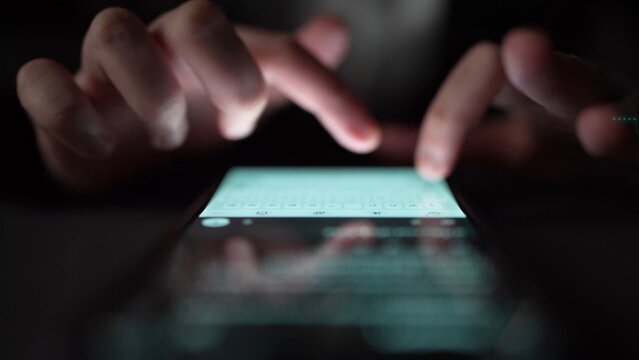 A close-up image showcasing hands typing on a smartphone screen illuminated by soft backlight at night, capturing the essence of modern digital communication and interaction. Xenic