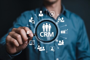 Man uses magnifying glass to examine crm customer relationship management icons