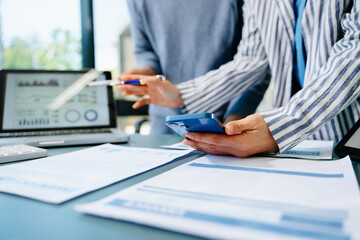 Fototapeta premium Team business meeting presentation. Hand businessman working project in modern office.Laptop computer and tablet and smart phone on white desk