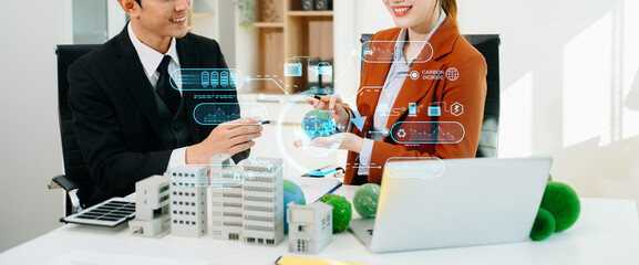 Business team reviewing eco technology with a futuristic digital interface. Green energy, sustainability, and innovation concept