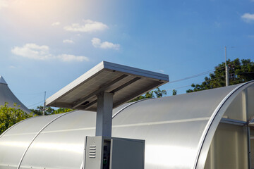 A large, arch-shaped solar dryer/greenhouse with an external solar panel and control box, illustrating the use of renewable energy for food preservation in agriculture.