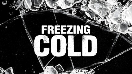 Text overlay reading freezing cold on a background of shattered ice fragments and cracked frozen water surface in high contrast black and white