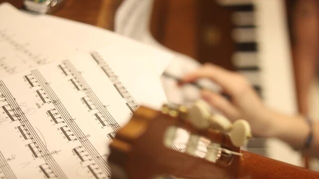 Vertical cinematic, musician's hands holding sheet music with violin bow at a concert. Perfect for storytelling , art, and education projects. music notes Moscow Russia 12.01.2025