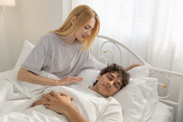 women gently waking up her partner in bed during peaceful morning, symbolizing love, care and calm couple relationship. Great for lifestyle, morning routine and relationship themes.