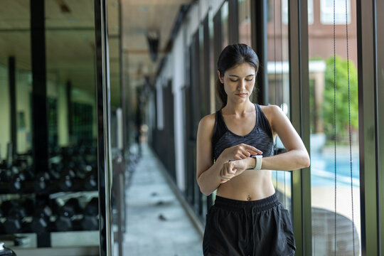 women checking smartwatch after workout, tracking fitness data and progress. Concept of smart technology in health, digital wellness and active lifestyle monitoring.