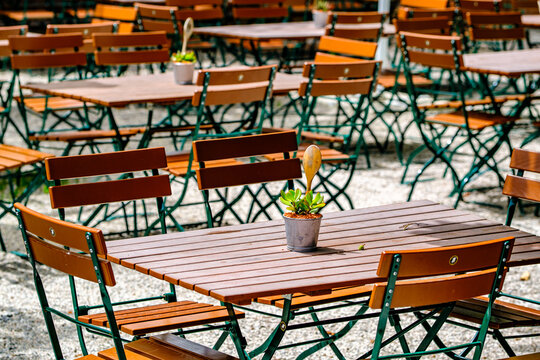 wooden benches and tables at a typical bavarian beergarden