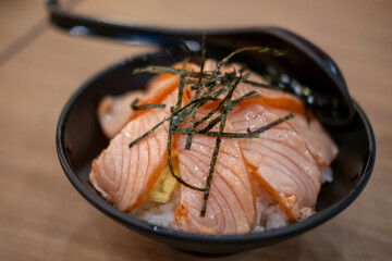 Grilled Salmon with rice, served in a bowl in the restaurant