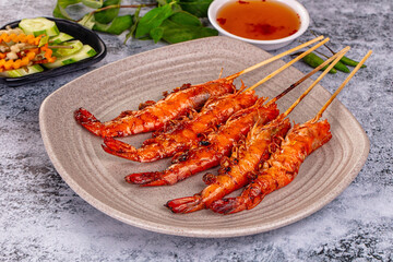 Grilled prawn skewer served sauce