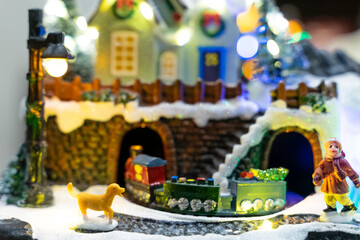 A beautifully crafted Christmas music box featuring reindeer, Santa figures, festive dolls, and a rotating carousel. The intricate design, warm lighting, and nostalgic holiday motifs create a magical 