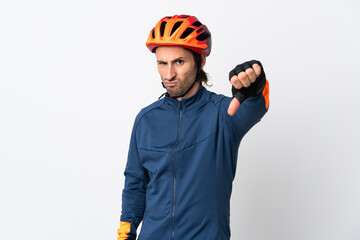 Young cyclist man isolated on white background showing thumb down with negative expression