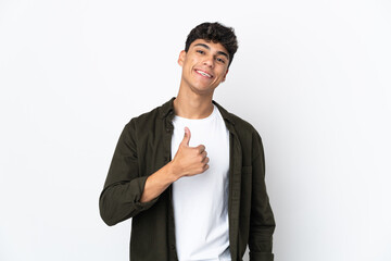 Young man over isolated white background giving a thumbs up gesture