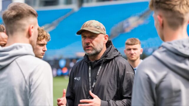 Coach passionately engages with young athletes during training session, emphasizing teamwork and strategy, camera zooms in on interaction and expressions, capturing dynamic moment