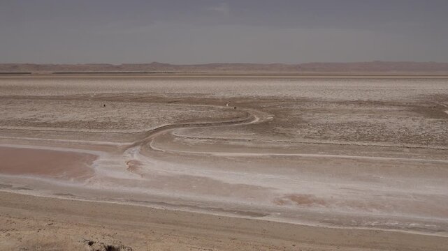Barren desert landscape of largely dried up salt lake of Chott El Djerid, natural scenery and wilderness in Tunisia
