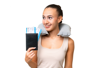 Young Arab woman with Inflatable Travel Pillow over isolated background looking to the side and smiling