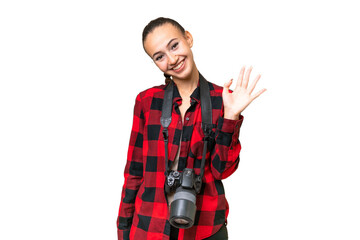 Young photographer Arab woman over isolated background saluting with hand with happy expression
