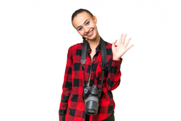 Young photographer Arab woman over isolated background saluting with hand with happy expression