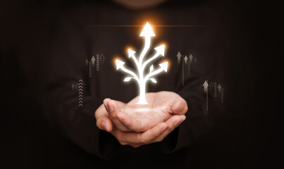 Hands holding glowing branching arrows. Multidimensional growth and progress, expanding opportunities, innovation, sustainability, spiritual path, forward progress in personal and professional fields.