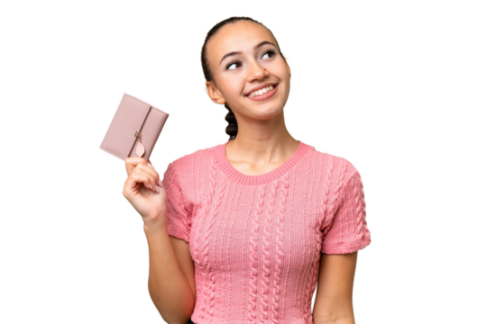 Young Arab woman holding a wallet over isolated background looking up while smiling - Powered by Adobe