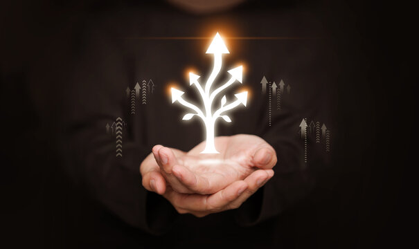Hands holding glowing branching arrows. Multidimensional growth and progress, expanding opportunities, innovation, sustainability, spiritual path, forward progress in personal and professional fields.